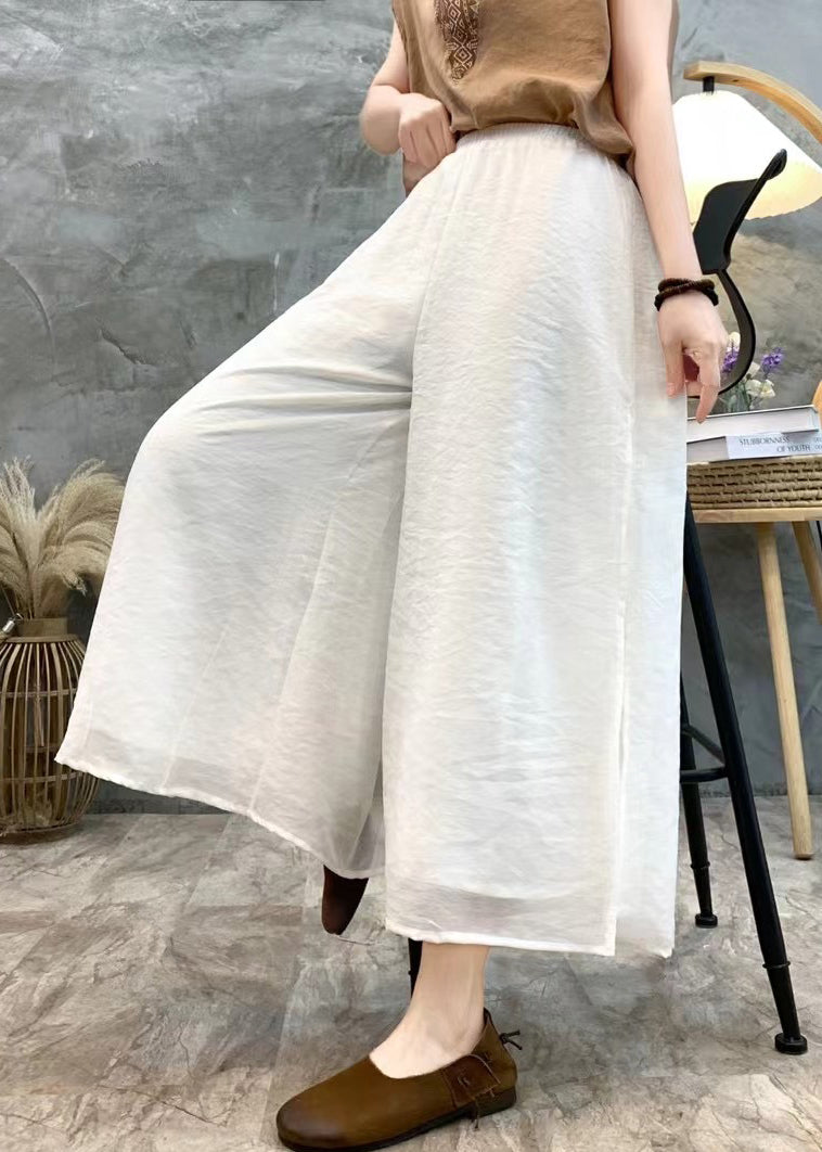 Pantalon court en lin blanc ample à taille élastique et ouverture latérale pour l'été AU1068